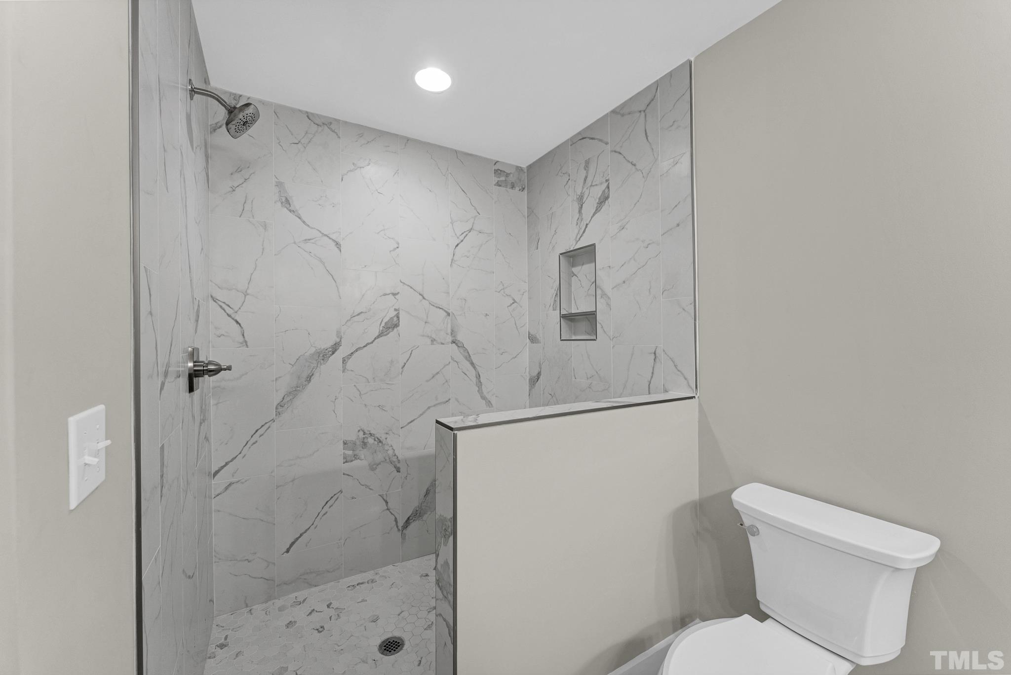 6712 Millbridge Court Raleigh, NC 27615 - Photo 21 of 25 a white toilet sitting next to a shower