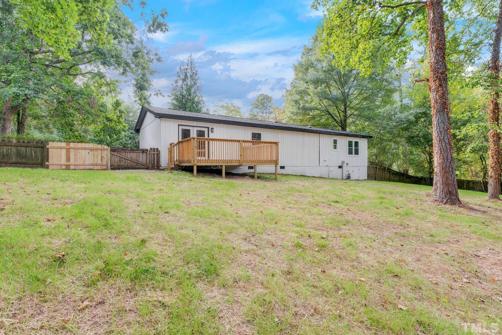 6712 Millbridge Court Raleigh, NC 27615 - Photo 24 of 25 a view of a house with a yard and sitting area