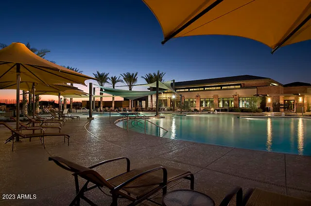 a swimming pool with outdoor seating and yard