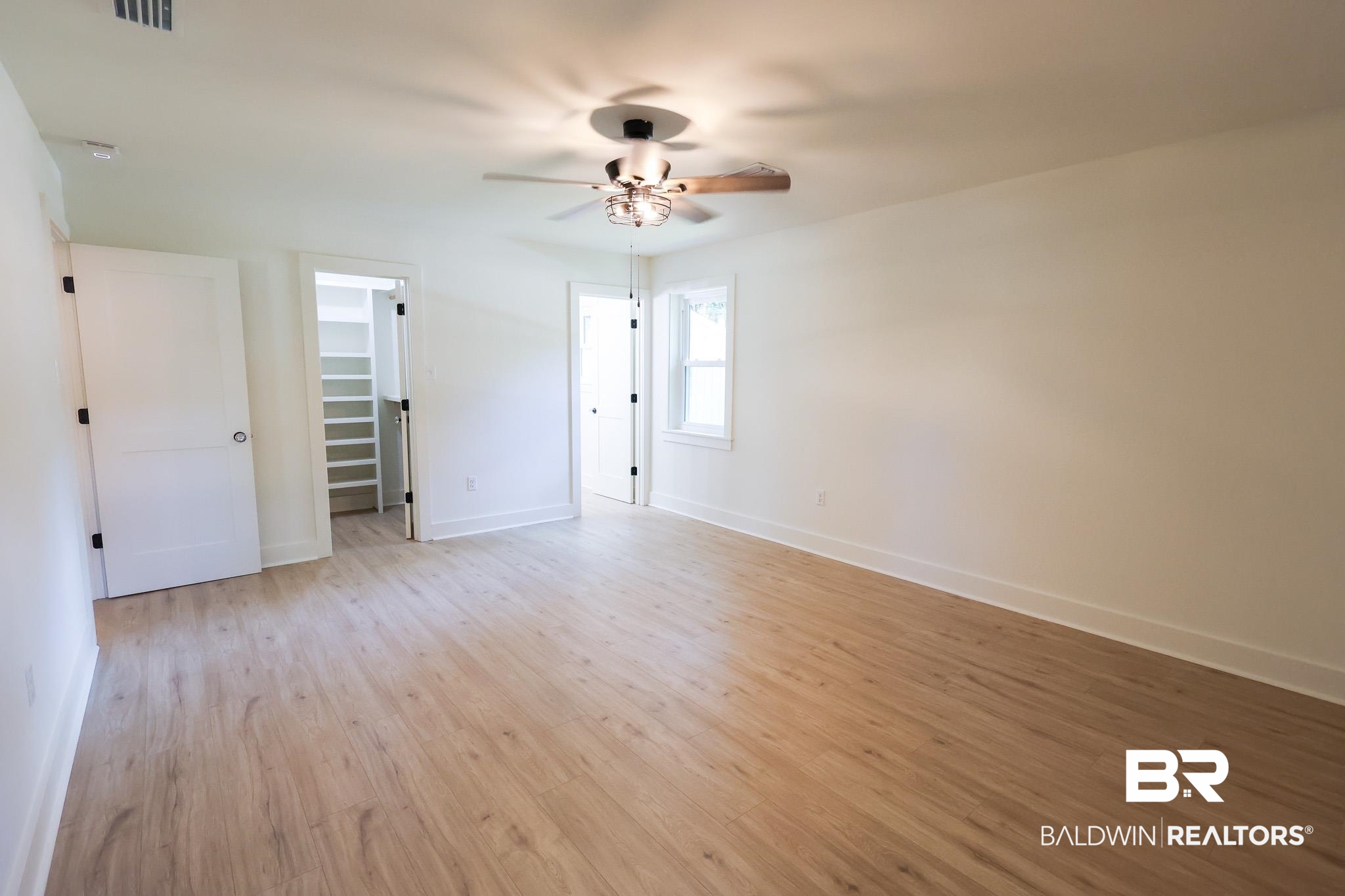 12190 Pecan Grove Street Magnolia Springs, AL 36555 - Photo 21 of 45 Unfurnished bedroom featuring ceiling fan, light hardwood / wood-style floors, and a spacious closet