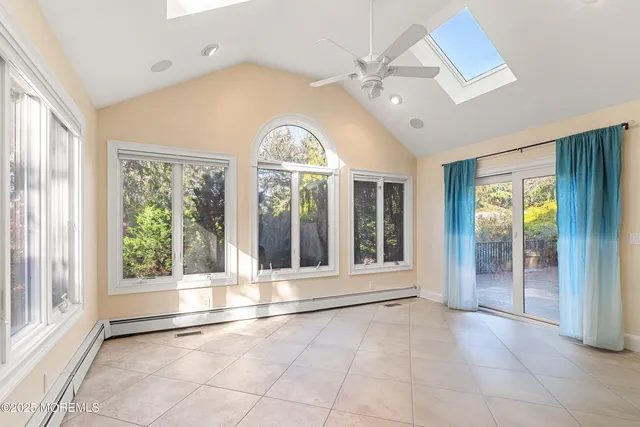 a view of an empty room with glass door and balcony