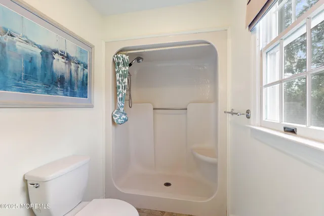 a bathroom with a shower and toilet