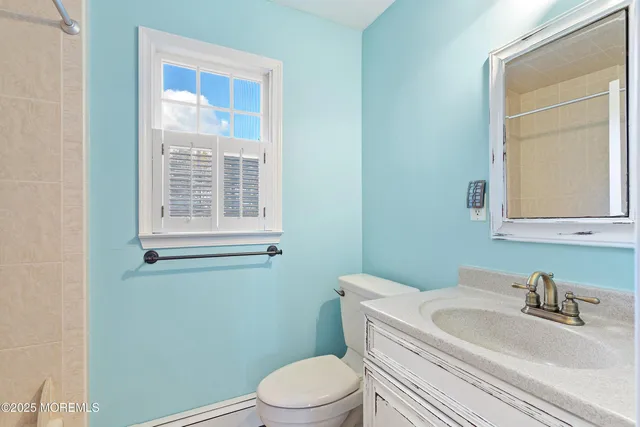 a bathroom with a sink toilet and mirror