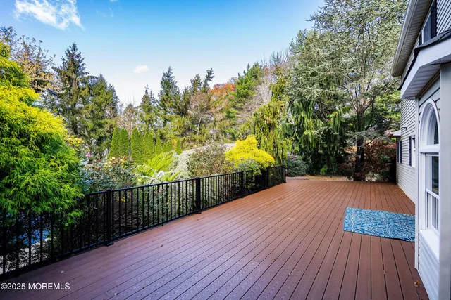 a view of a balcony with wooden floor and fence