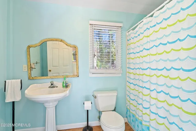a bathroom with a sink a mirror and a toilet