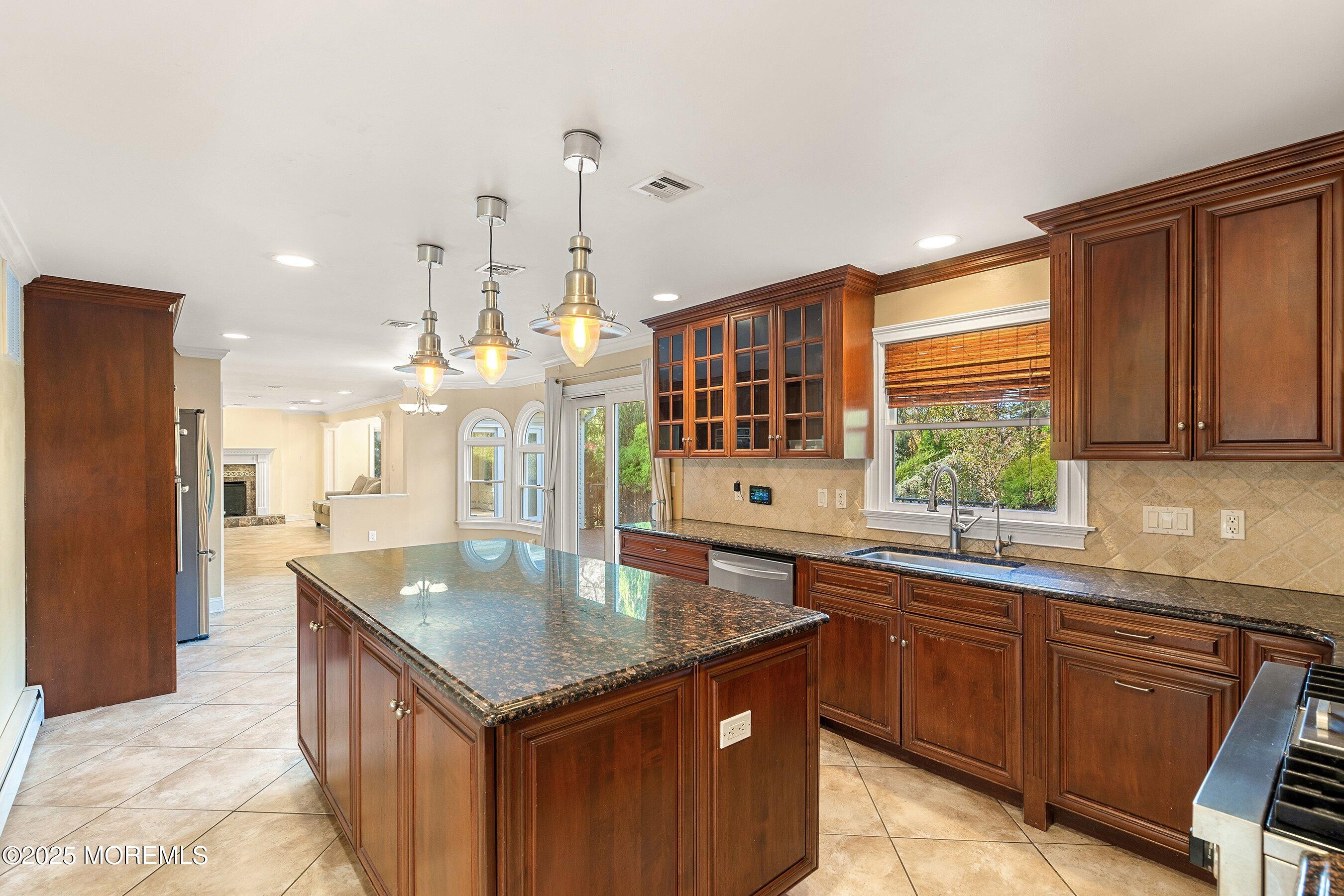 677 Overlook Court Brick, NJ 08724 - Photo 5 of 26 a kitchen with stainless steel appliances granite countertop a sink a stove and a refrigerator