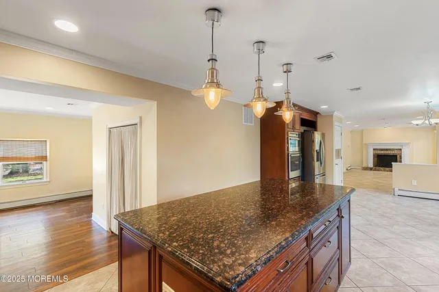 a kitchen with stainless steel appliances granite countertop a sink a oven and a refrigerator