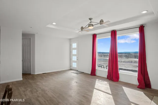 a workspace with wooden floor and a window