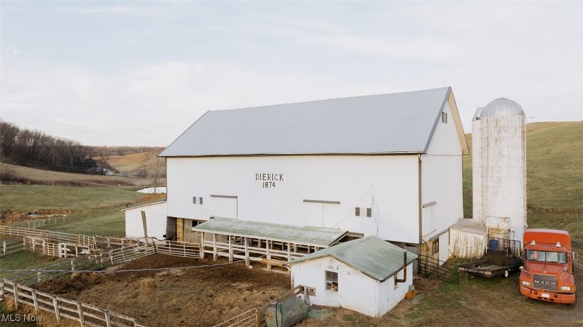 8091 Fargo Road Southwest Dellroy, OH 44620 - Photo 21 of 29 View of barn featuring a rural view and fence