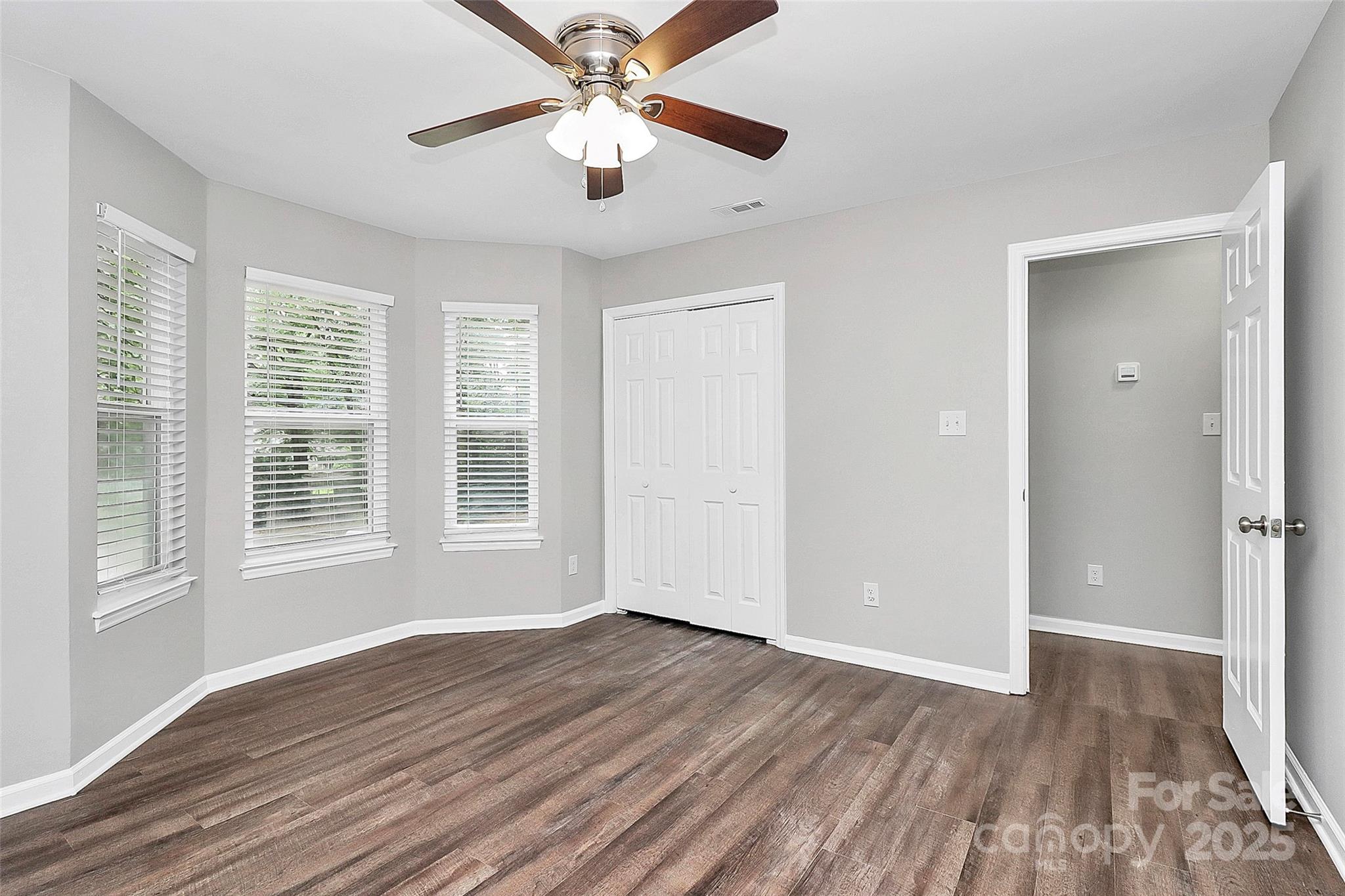 1540 Nichole Lane Fort Mill, SC 29708 - Photo 21 of 33 an empty room with wooden floor chandelier fan and windows