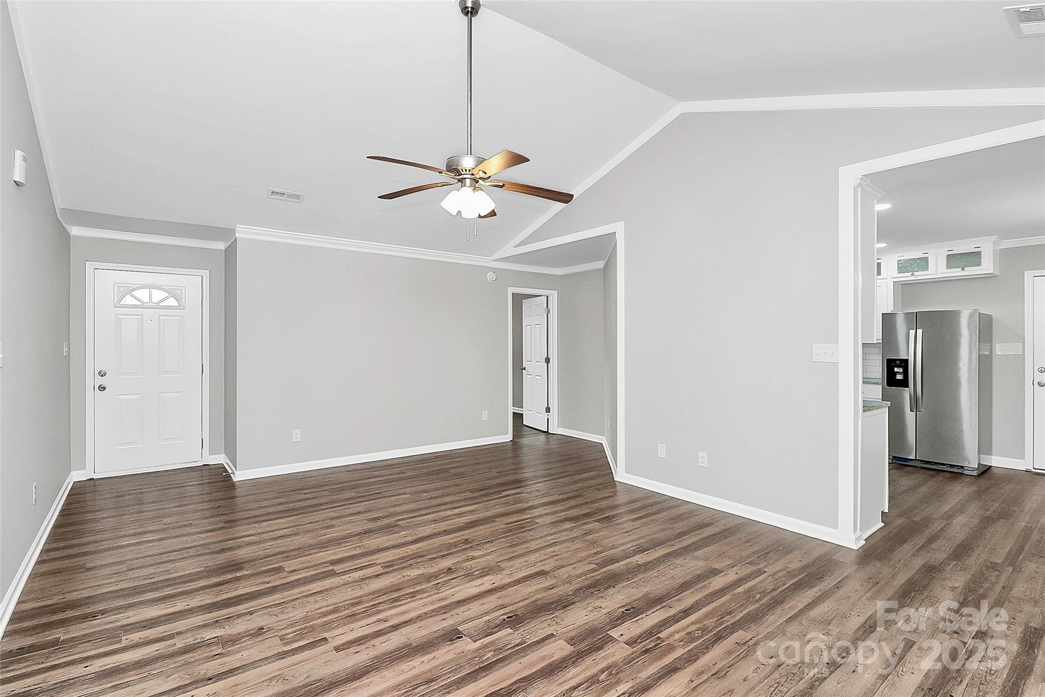 1540 Nichole Lane Fort Mill, SC 29708 - Photo 4 of 33 a view of an empty room with wooden floor and a ceiling fan