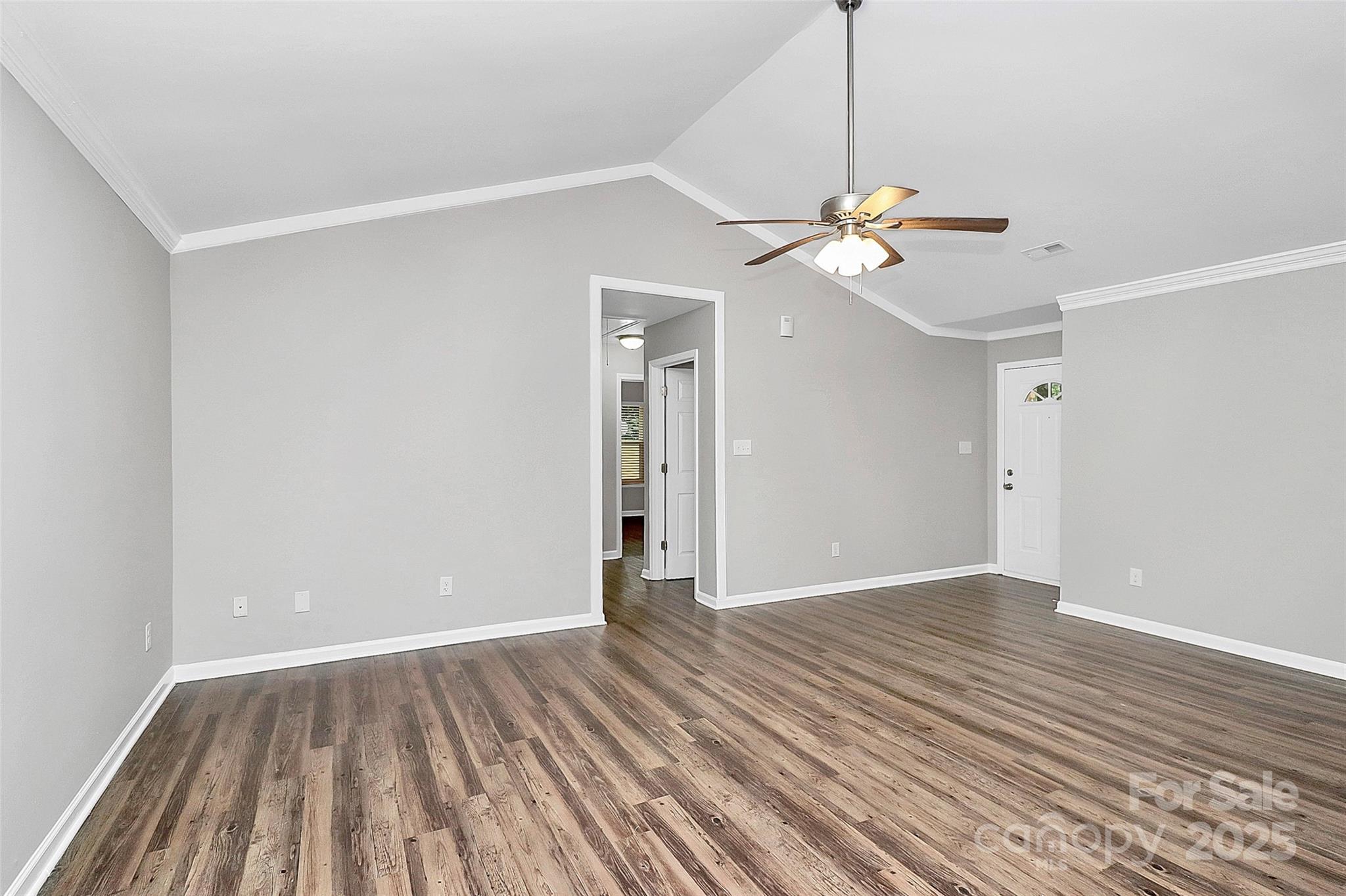 1540 Nichole Lane Fort Mill, SC 29708 - Photo 5 of 33 a view of a room with wooden floor and a ceiling fan