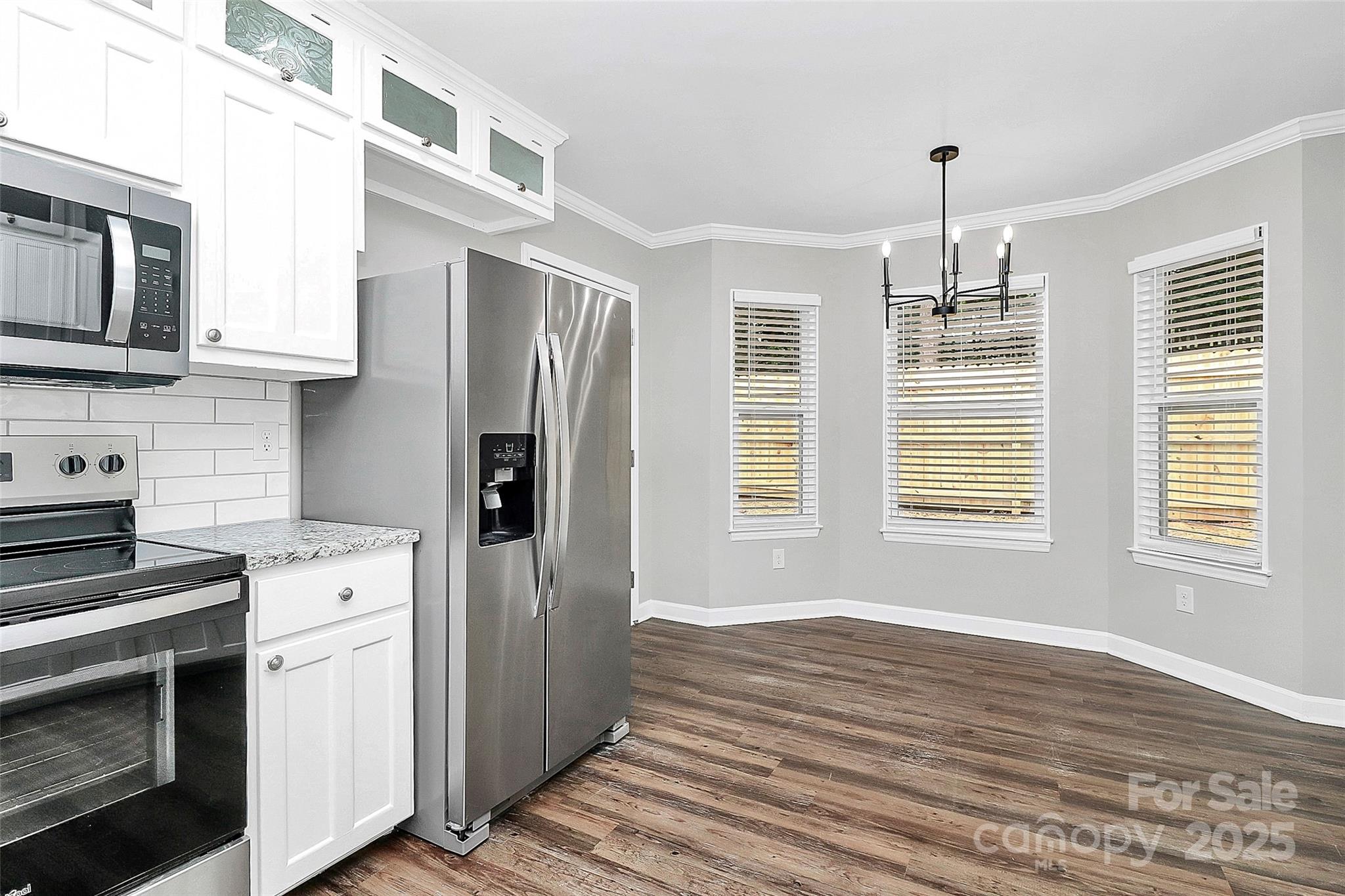 1540 Nichole Lane Fort Mill, SC 29708 - Photo 7 of 33 a kitchen with stainless steel appliances a stove microwave and refrigerator