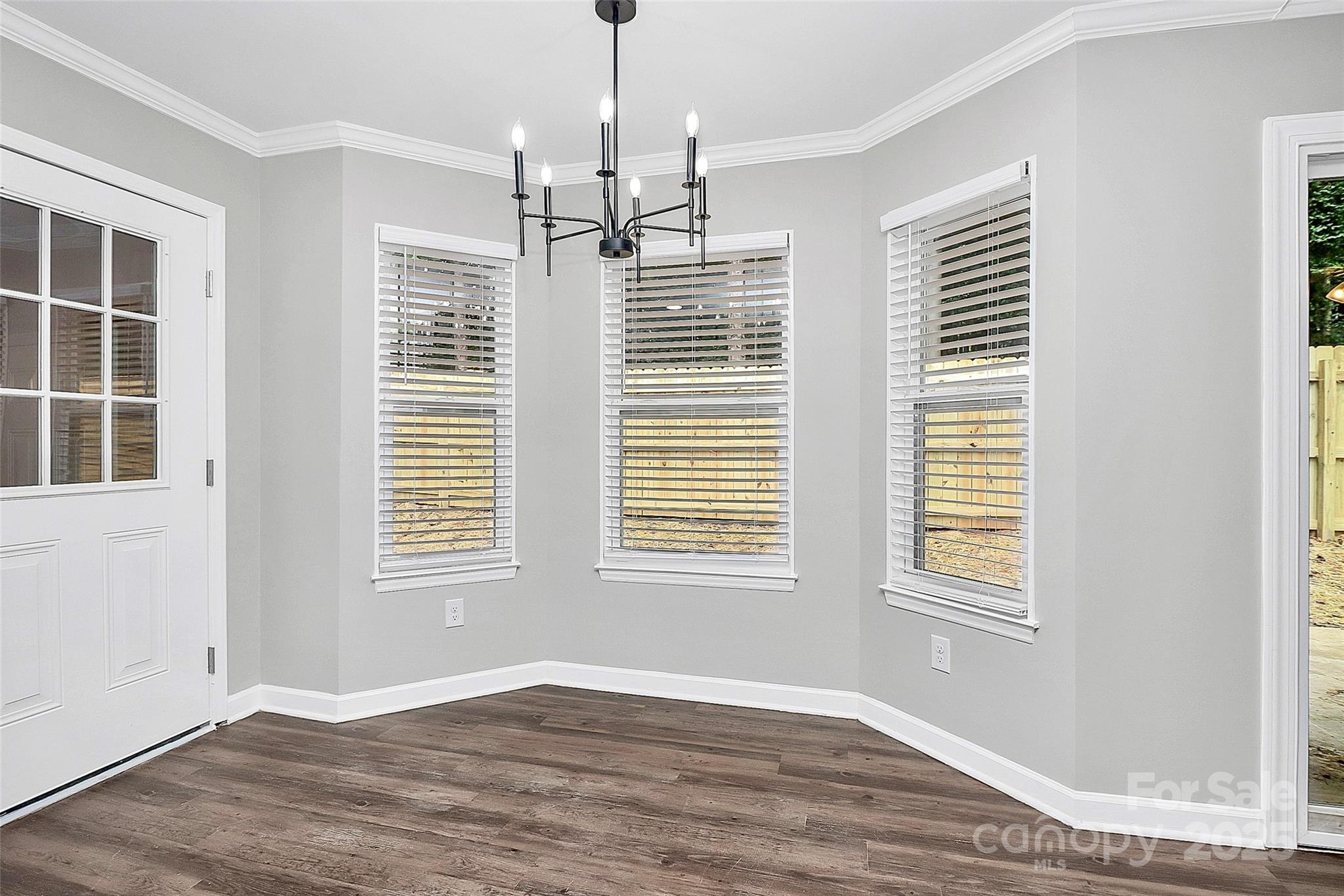 1540 Nichole Lane Fort Mill, SC 29708 - Photo 8 of 33 a view of an empty room with a window and wooden floor