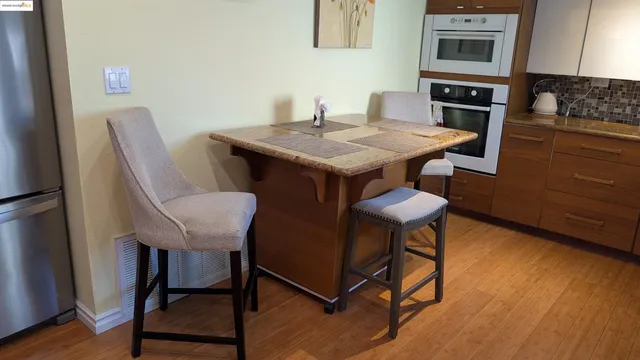 a dining room with furniture and wooden floor