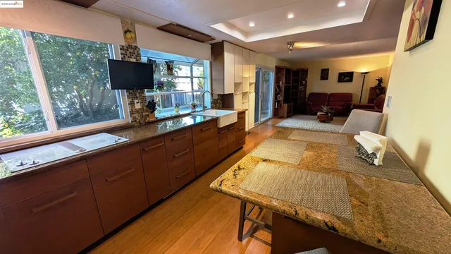 a living room with furniture pool table and flat screen tv