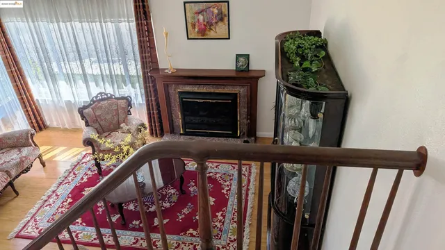 a view of a balcony with chairs and a fireplace