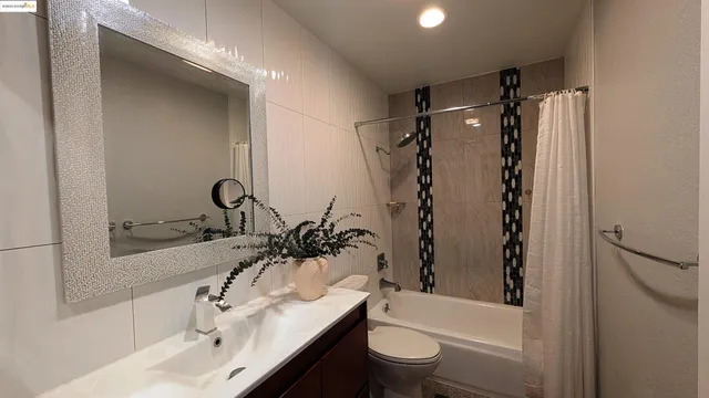 a bathroom with a sink toilet tub and shower