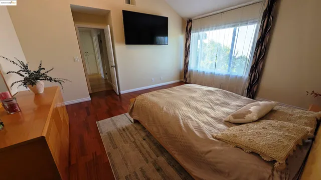 a bedroom with a bed and a flat screen tv