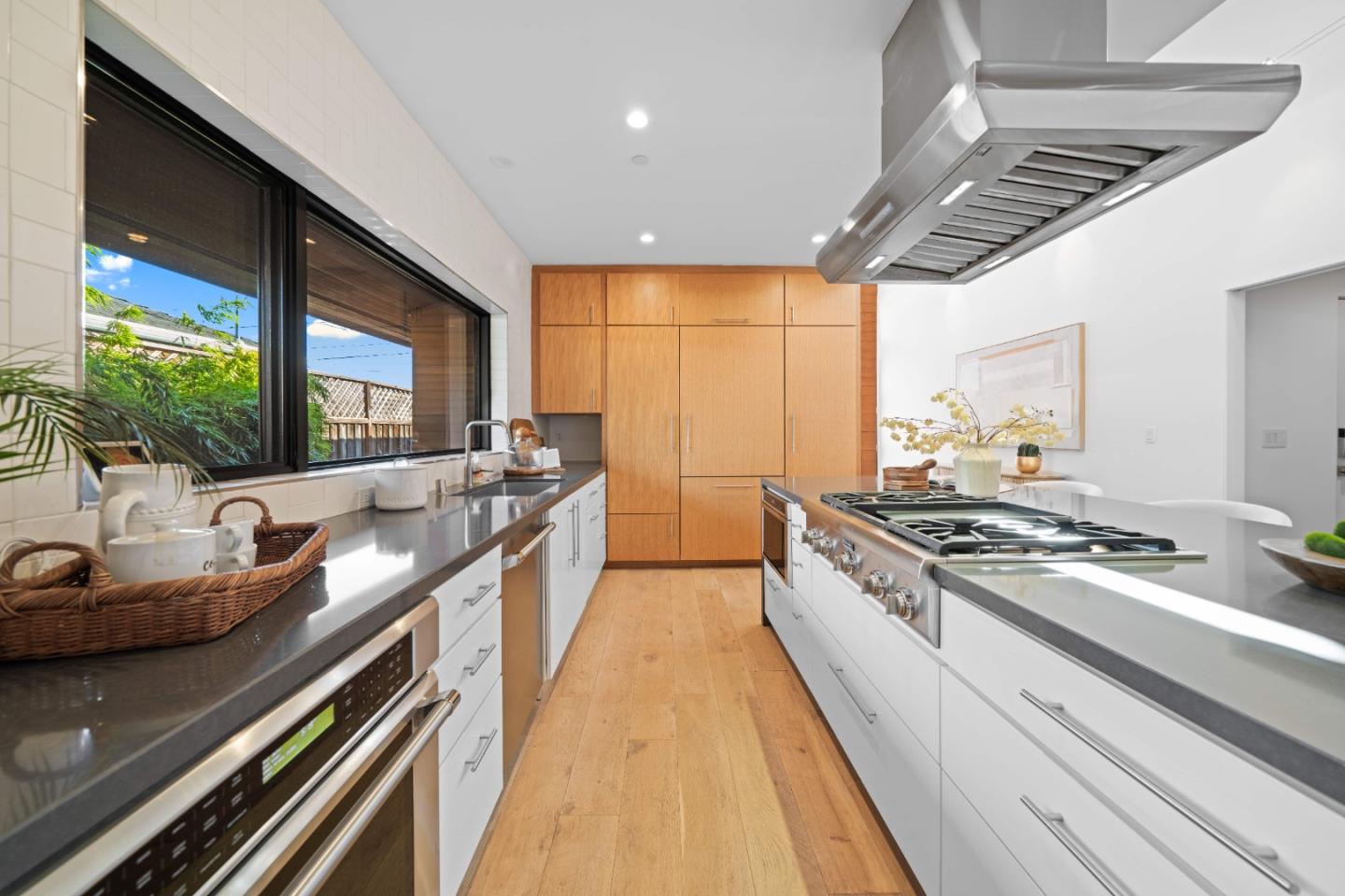 359 Stowell Avenue Sunnyvale, CA 94085 - Photo 15 of 53 a kitchen with stainless steel appliances granite countertop a sink a stove and a wooden floor