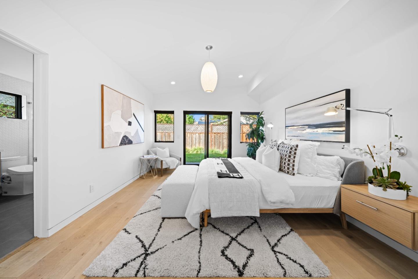 359 Stowell Avenue Sunnyvale, CA 94085 - Photo 21 of 53 a spacious bedroom with a bed and a chandelier