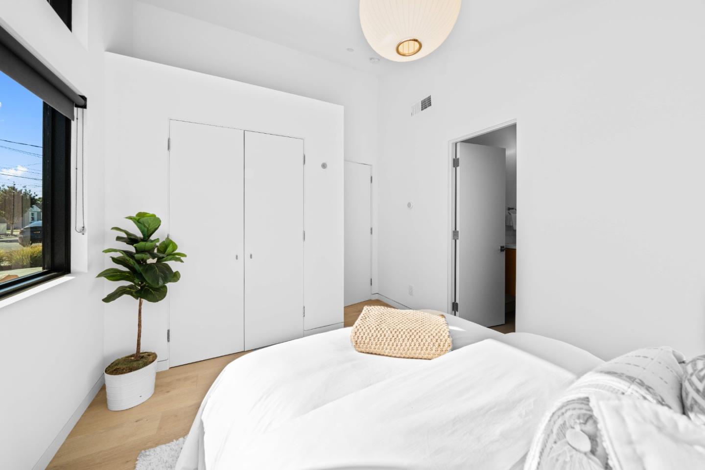 359 Stowell Avenue Sunnyvale, CA 94085 - Photo 27 of 53 a bedroom with a bed and a potted plant