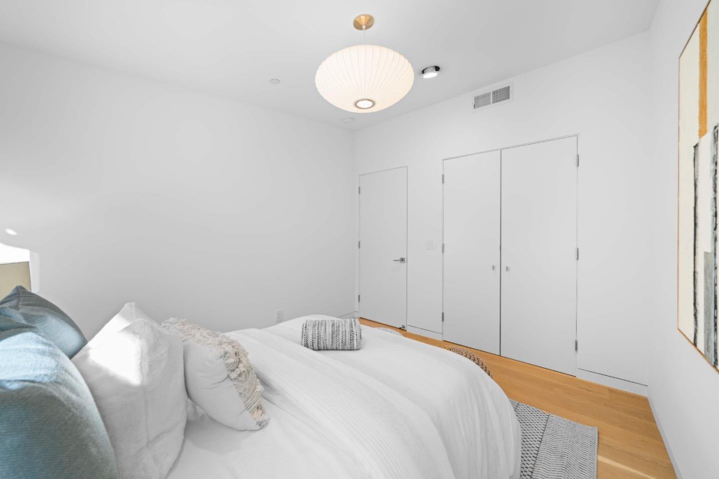 359 Stowell Avenue Sunnyvale, CA 94085 - Photo 29 of 53 a bedroom with a bed and a chandelier