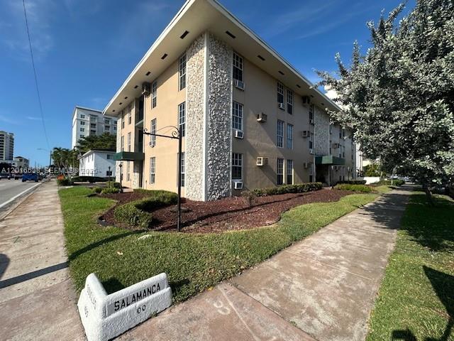 1400 Douglas Road, Unit 14 Coral Gables, FL 33134 - Photo 3 of 19 a front view of a house with a yard