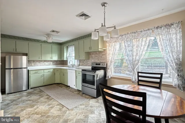 a kitchen with sink cabinets and window