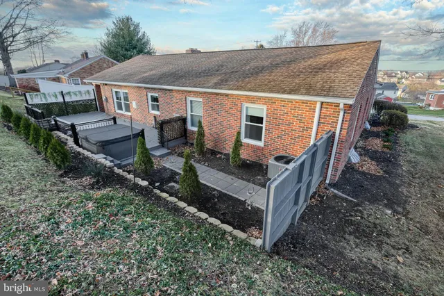 an aerial view of a house with yard and roof