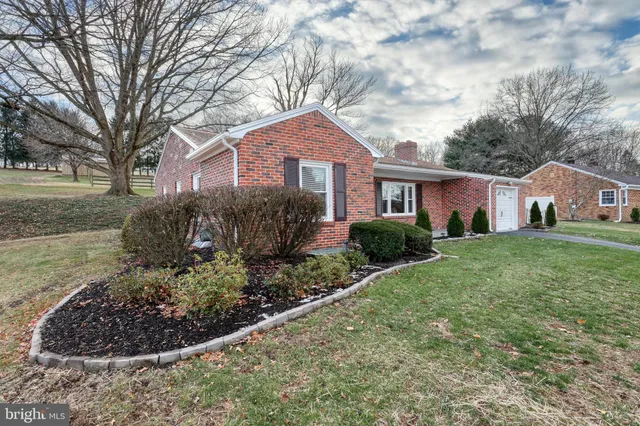 a house view with a garden and trees