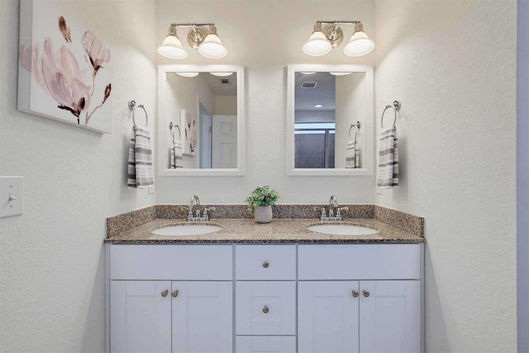 11008 Players Path Austin, TX 78747 - Photo 14 of 26 Granite counters and dual sinks elevate this modern vanity space.