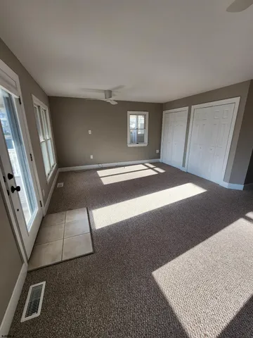 a view of an empty room with windows