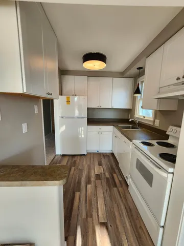 a kitchen with granite countertop a sink and a stove top oven
