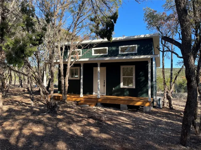 a view of a building with large tree and many windows