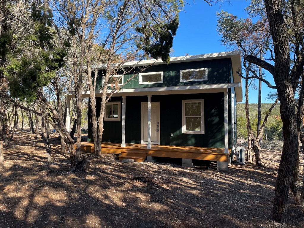 a view of a building with large tree and many windows