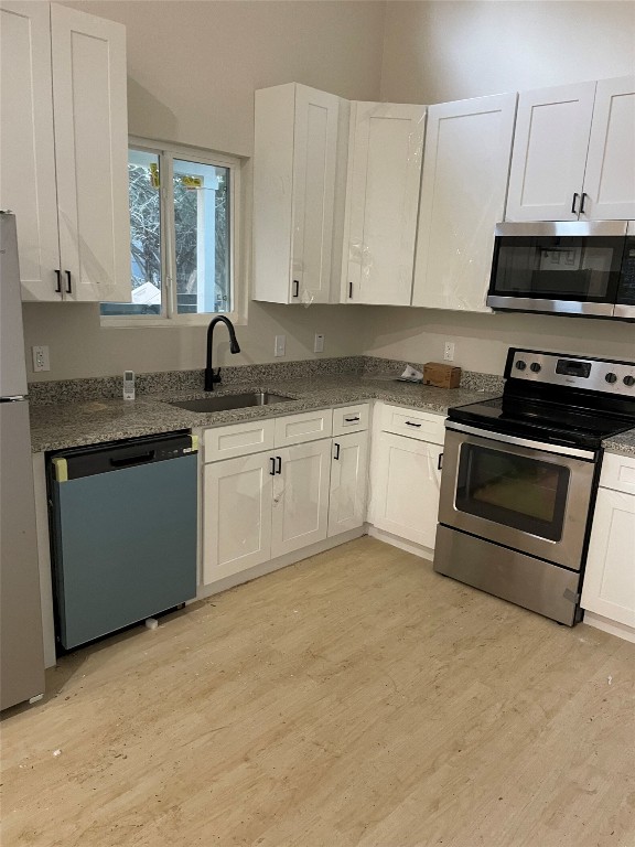 23081 Nameless Road, Unit I Leander, TX 78641 - Photo 2 of 15 a kitchen with stainless steel appliances granite countertop a stove a sink and a microwave