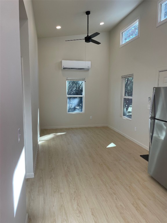 23081 Nameless Road, Unit I Leander, TX 78641 - Photo 7 of 15 a view of an empty room with a window and wooden floor