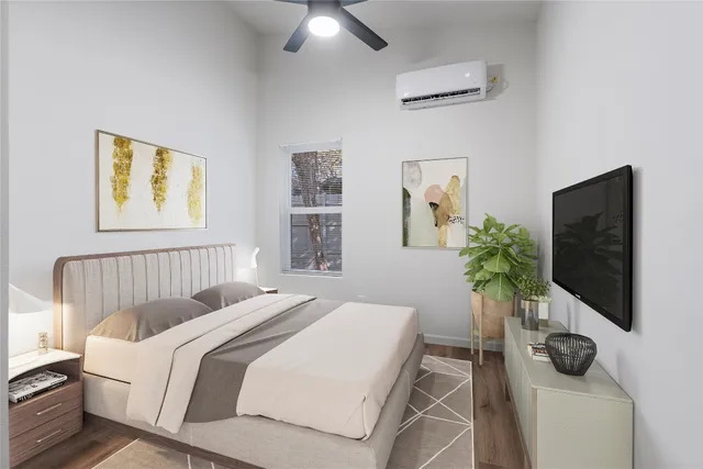 a bedroom with a bed and flat screen tv