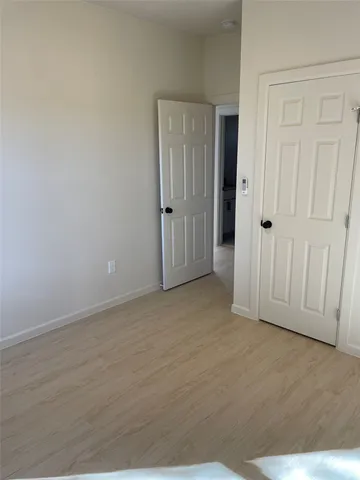 a bedroom with bed and a window