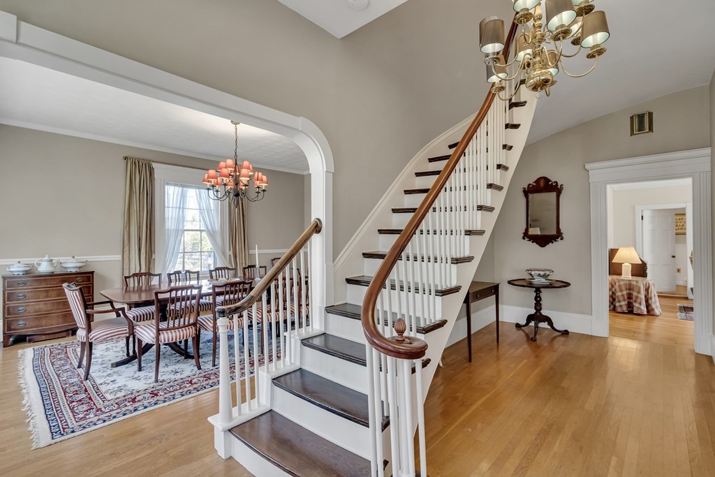 a view of a dining room with furniture chandelier and wooden floor