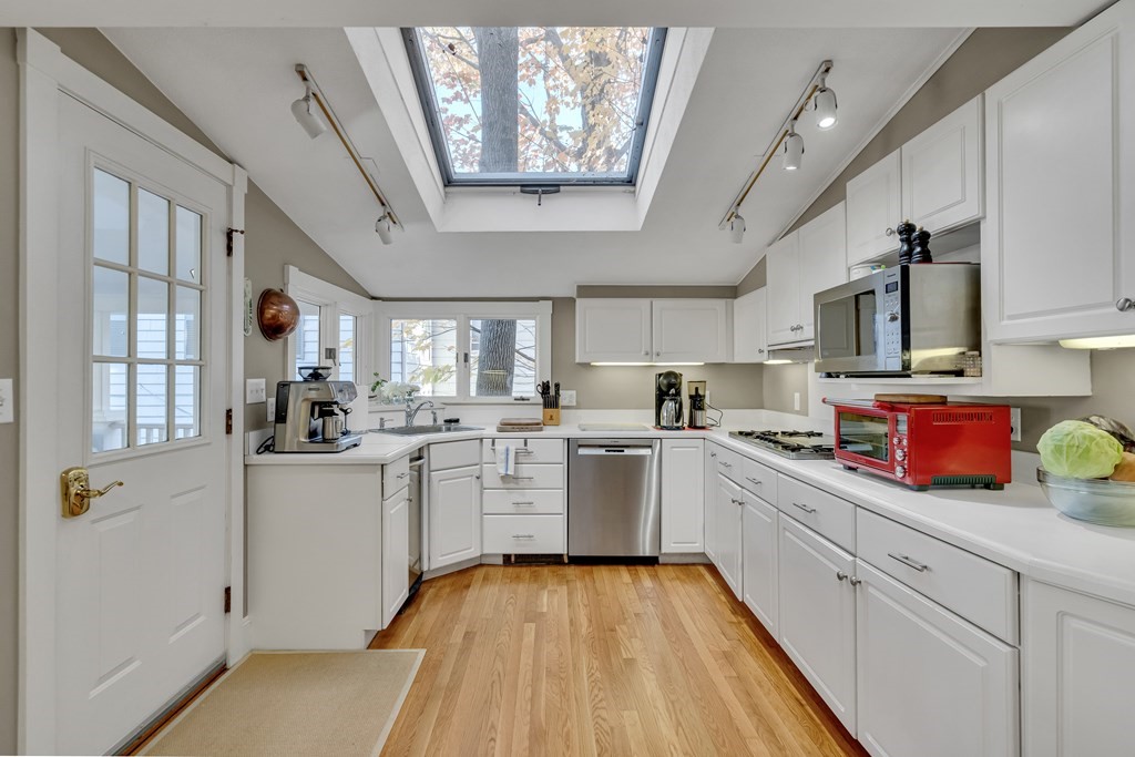 176 Pleasant Street Arlington, MA 02476 - Photo 13 of 41 a kitchen with sink cabinets and window