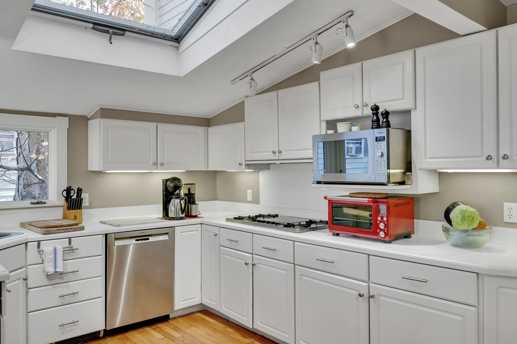 176 Pleasant Street Arlington, MA 02476 - Photo 14 of 41 a kitchen with cabinets appliances a sink and a counter top space