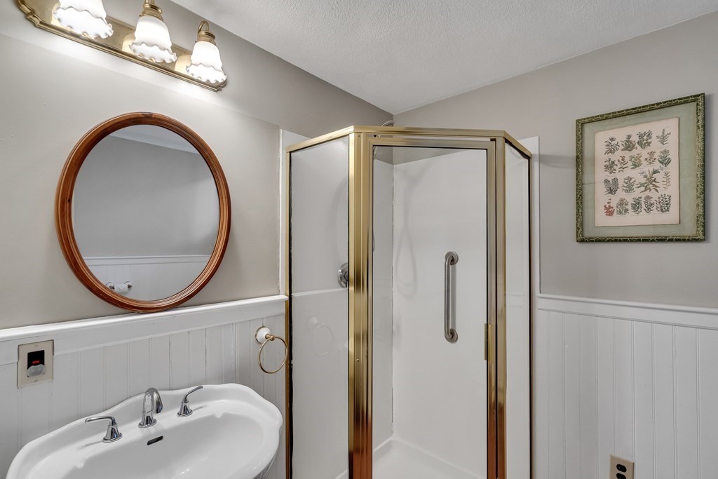 176 Pleasant Street Arlington, MA 02476 - Photo 20 of 41 a bathroom with a sink and a mirror