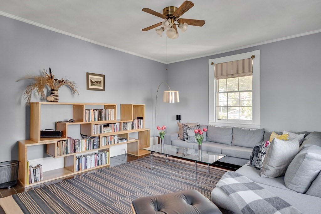 176 Pleasant Street Arlington, MA 02476 - Photo 22 of 41 a living room with furniture and a book shelf