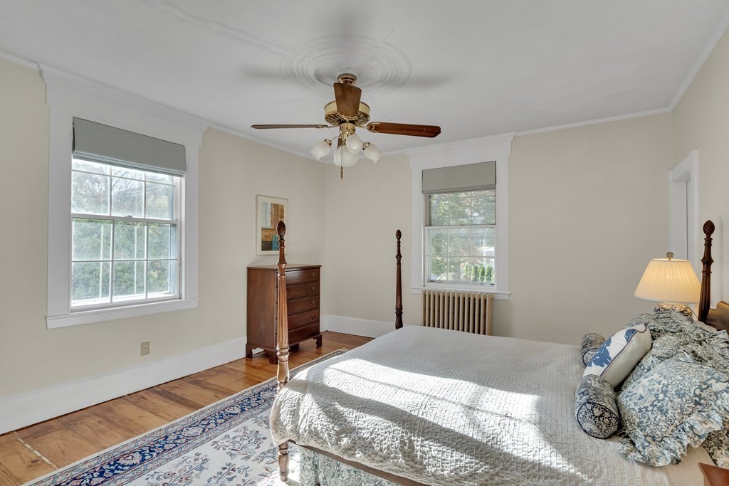 176 Pleasant Street Arlington, MA 02476 - Photo 23 of 41 a bedroom with a bed and a chandelier