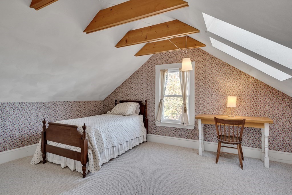 176 Pleasant Street Arlington, MA 02476 - Photo 29 of 41 a bedroom with a bed a lamp and a window