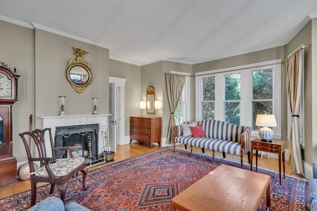 176 Pleasant Street Arlington, MA 02476 - Photo 3 of 41 a living room with furniture a fireplace and a large window