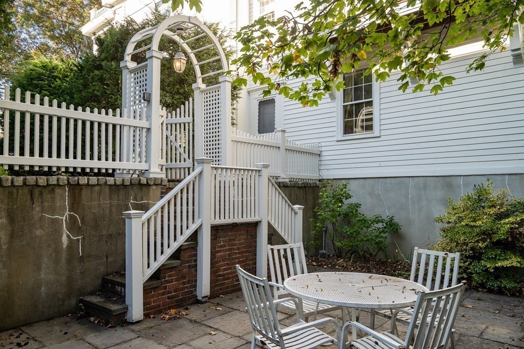 176 Pleasant Street Arlington, MA 02476 - Photo 34 of 41 a view of a chair and table in backyard