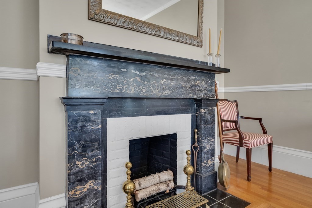 176 Pleasant Street Arlington, MA 02476 - Photo 10 of 41 a living room with a fireplace and a wooden floor